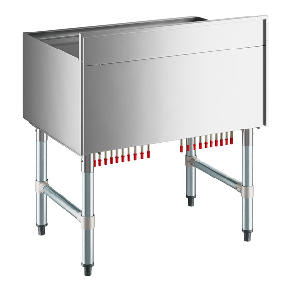 A Regency stainless steel underbar ice bin with a sliding lid and tubes attached to it.