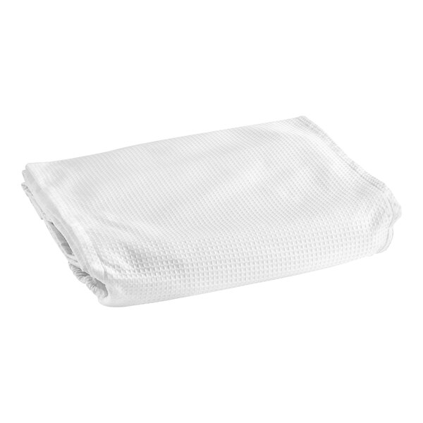 A folded white 1888 Mills Adorn box spring cover on a white surface.