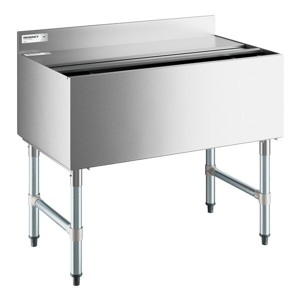 A stainless steel underbar ice bin with a sliding lid, elevated on four metal legs with cross supports.