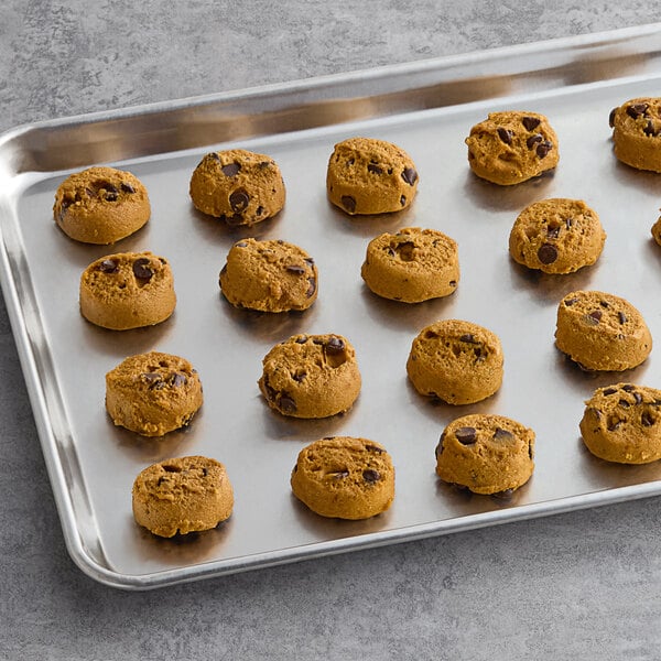 A tray of Otis Spunkmeyer Pumpkin Spice Chocolate Chip cookies on a gray surface.