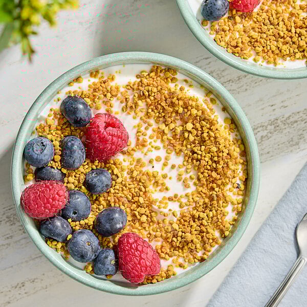 A bowl of yogurt topped with berries.