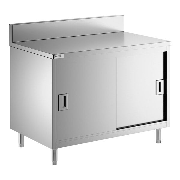 A stainless steel enclosed base table with sliding doors, a midshelf, and a 6-inch backsplash.