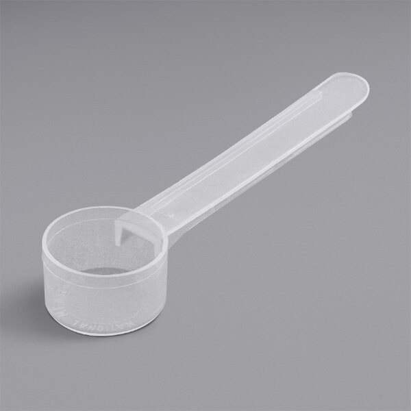 A plastic measuring spoon with a long handle.