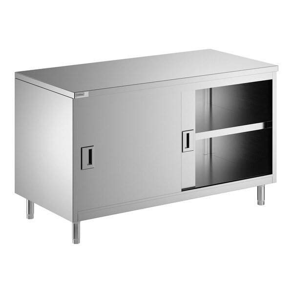 A stainless steel enclosed base table with sliding doors and a midshelf.