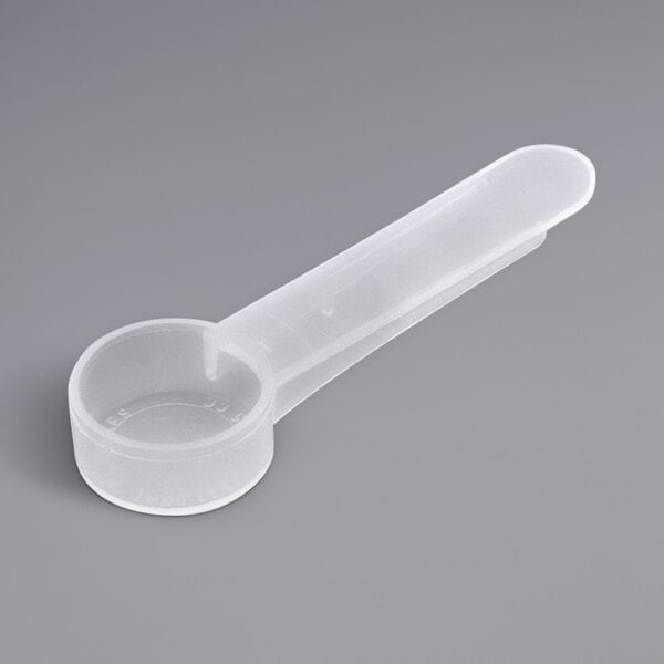 A white plastic measuring spoon with a medium handle.
