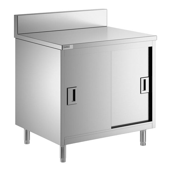 A stainless steel enclosed base table with sliding doors, a midshelf, and a 6-inch backsplash.