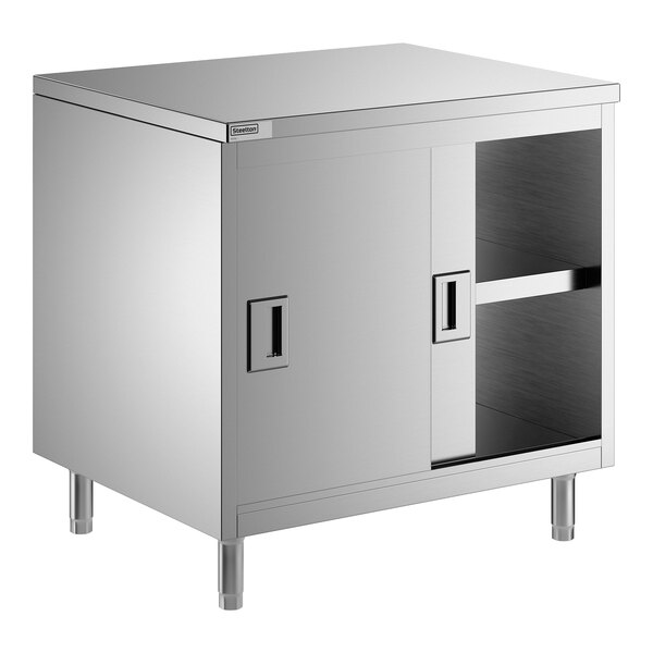 A stainless steel enclosed base table with sliding doors and a midshelf.