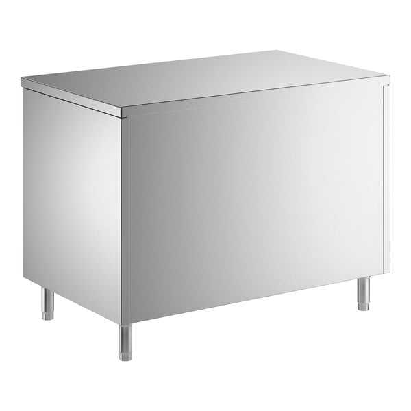 A stainless steel enclosed base table with sliding doors and a midshelf.