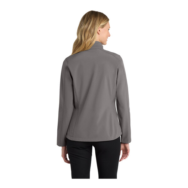 A woman wearing a Port Authority deep smoke grey soft shell jacket.