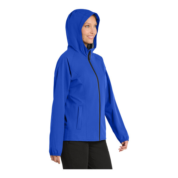A woman wearing a blue Port Authority rain jacket.