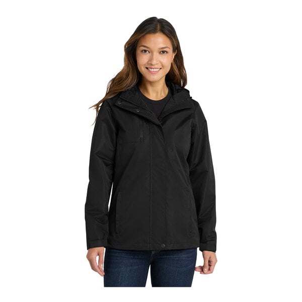 A woman wearing a black Port Authority parka jacket.