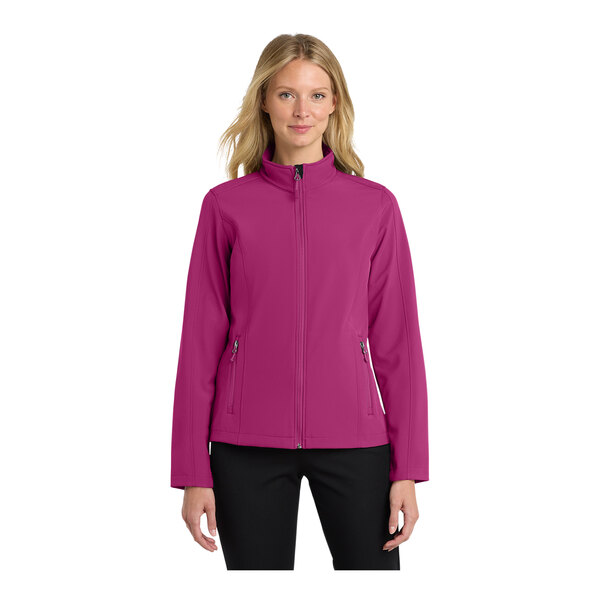 A woman wearing a Port Authority very berry soft shell jacket.