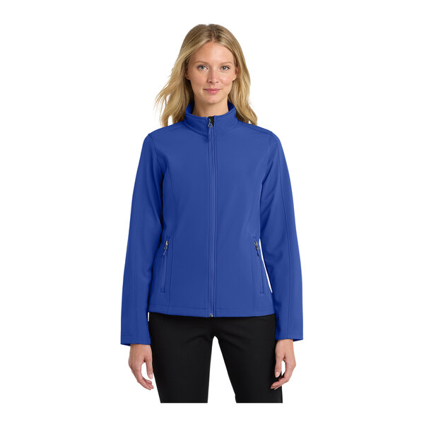 A woman wearing a Port Authority blue soft shell jacket.