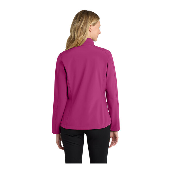 A woman wearing a Port Authority very berry soft shell jacket.