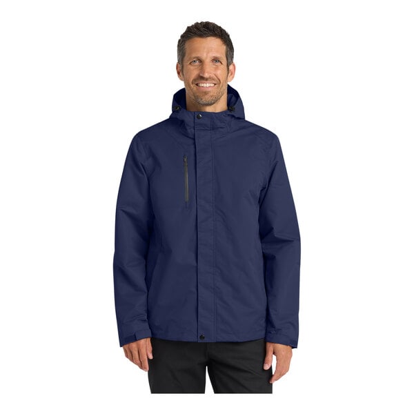 A person wearing a Port Authority True Navy All-Conditions Parka Jacket.