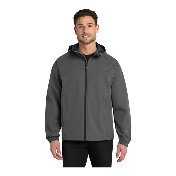 A man wearing a graphite Port Authority Essential Rain Jacket.