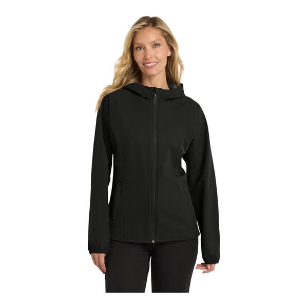 A woman wearing a Port Authority black rain jacket.