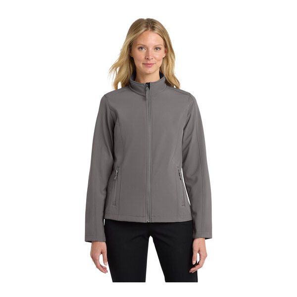 A woman wearing a Port Authority deep smoke grey soft shell jacket.