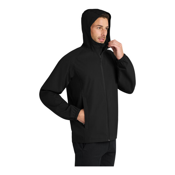 A man wearing a black Port Authority Essential Rain Jacket.