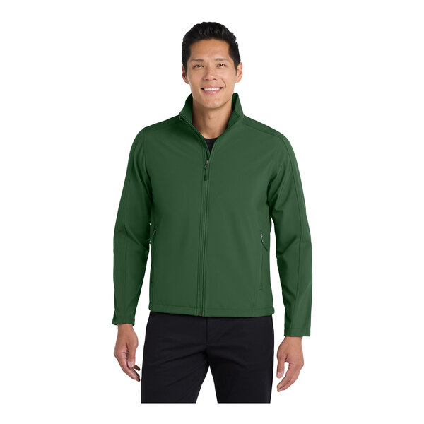 A man wearing a Port Authority forest green soft shell jacket.