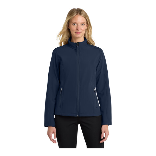 A woman wearing a Port Authority blue soft shell jacket.