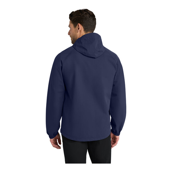 A man wearing a Port Authority True Navy Essential Rain Jacket with a hood.