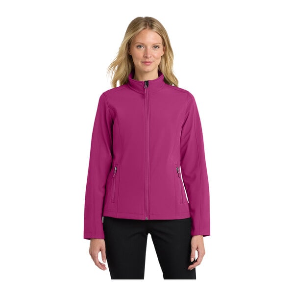 A woman wearing a Port Authority very berry soft shell jacket.