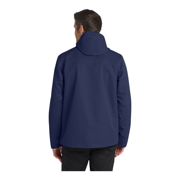 A person wearing a Port Authority True Navy Parka jacket.