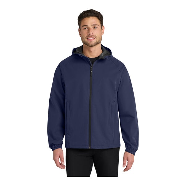 A man wearing a navy Port Authority rain jacket with black trim.