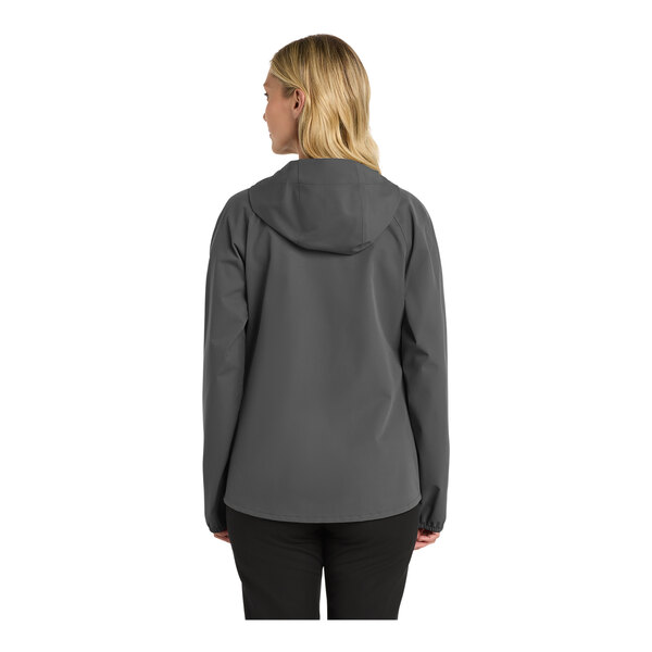 A woman wearing a graphite Port Authority rain jacket.
