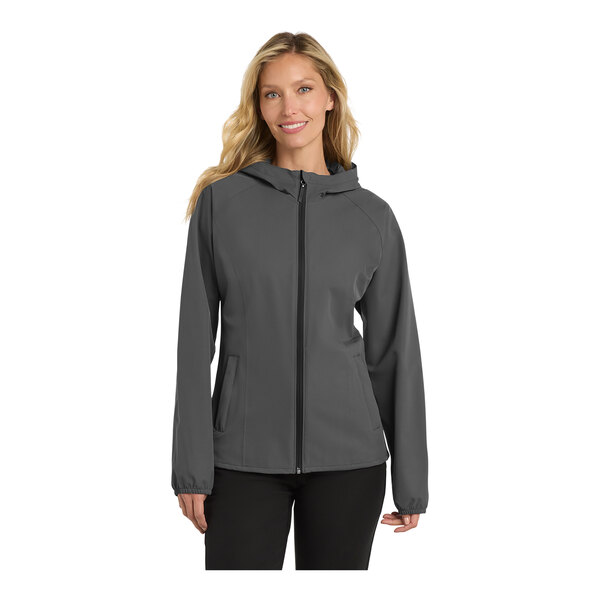 A woman wearing a graphite Port Authority rain jacket.