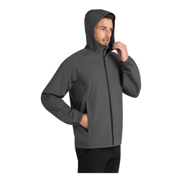 A man wearing a graphite Port Authority Essential Rain Jacket.