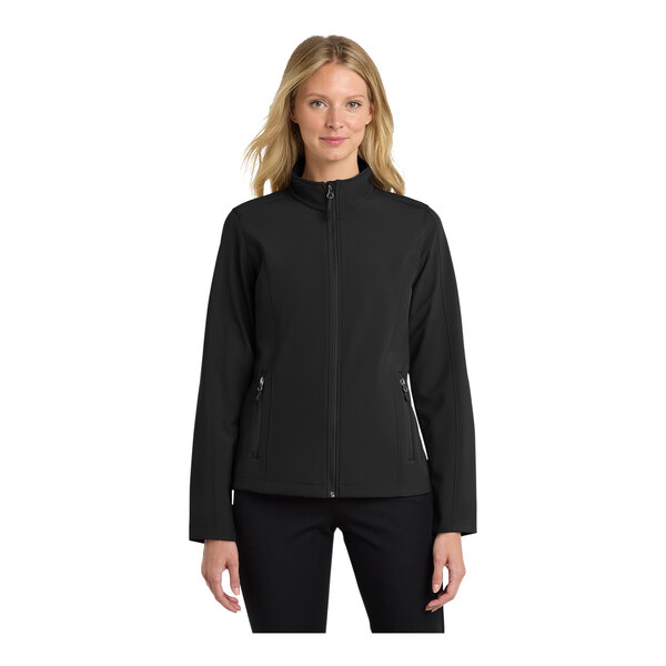 A woman wearing a black Port Authority Core Soft Shell Jacket.