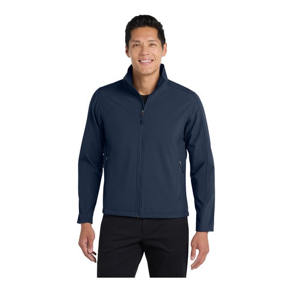 A man wearing a Port Authority blue core soft shell jacket.