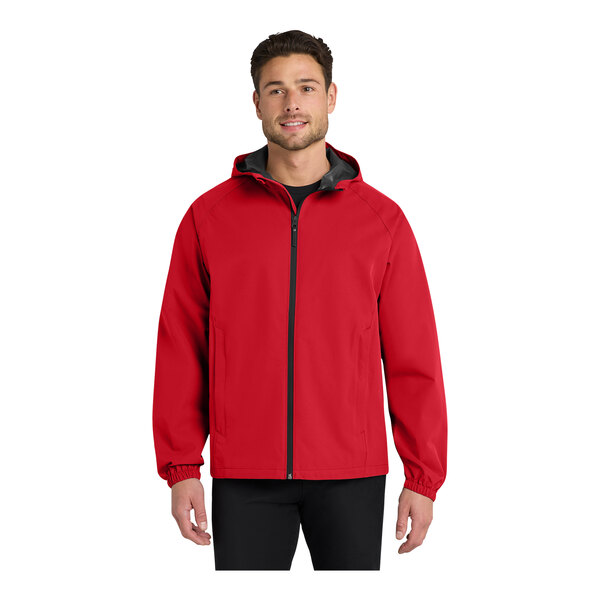 A man wearing a Port Authority red rain jacket.