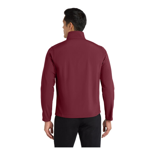 A man wearing a maroon Port Authority core soft shell jacket with a full-zip.