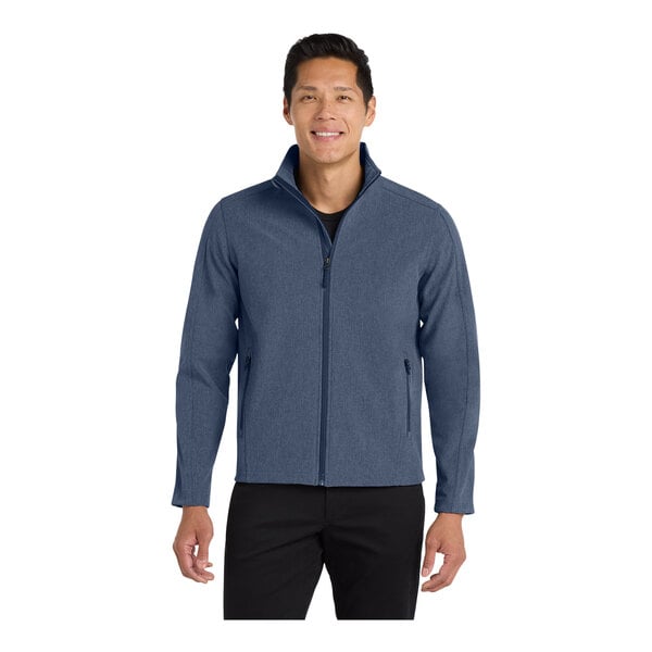 A man wearing a navy blue Port Authority Core Soft Shell Jacket with a full-zip closure.