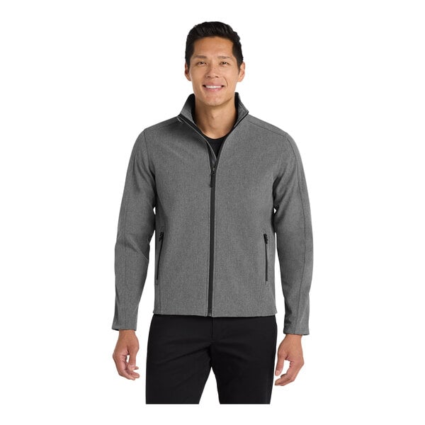 A man wearing a Port Authority Core Soft Shell Jacket in pearl gray heather.