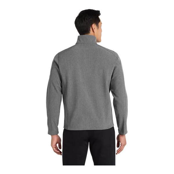 A man wearing a Port Authority pearl gray heather soft shell jacket with a custom logo.