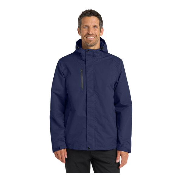 A person wearing a Port Authority navy blue parka jacket.