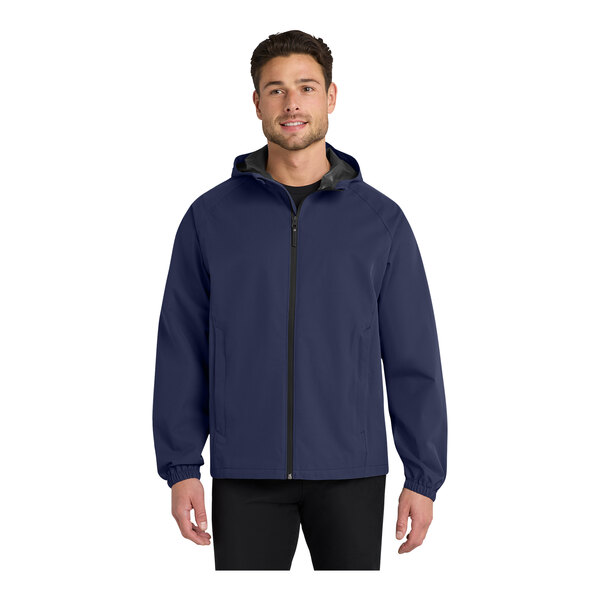 A man wearing a navy Port Authority rain jacket with black trim.