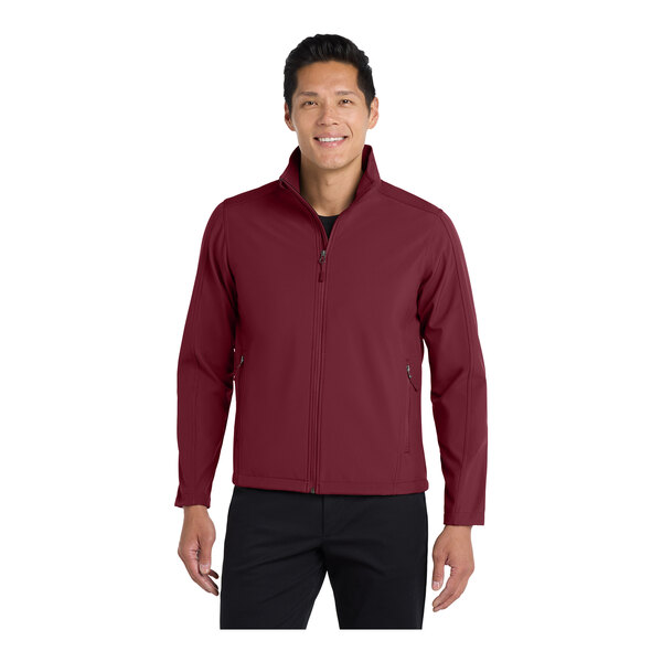A man wearing a maroon Port Authority core soft shell jacket.
