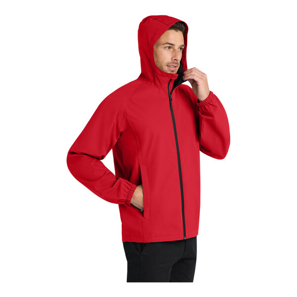 A man wearing a red Port Authority Essential Rain Jacket.