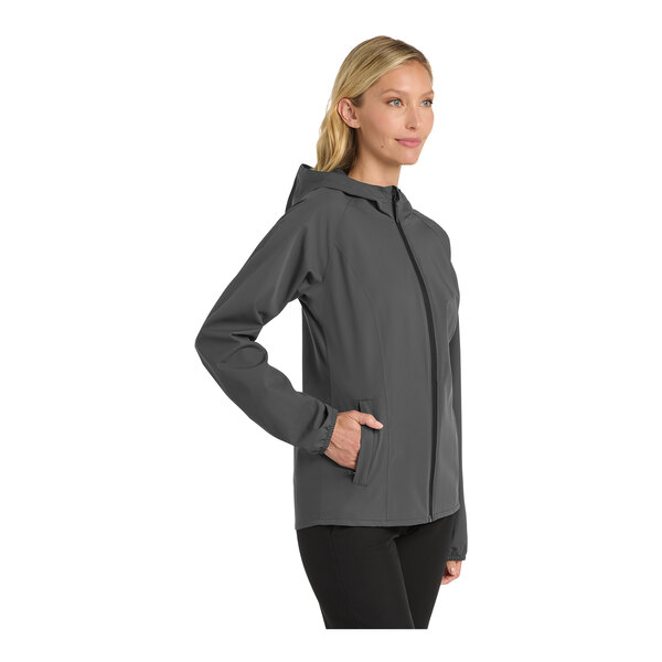 A woman wearing a Port Authority graphite rain jacket.