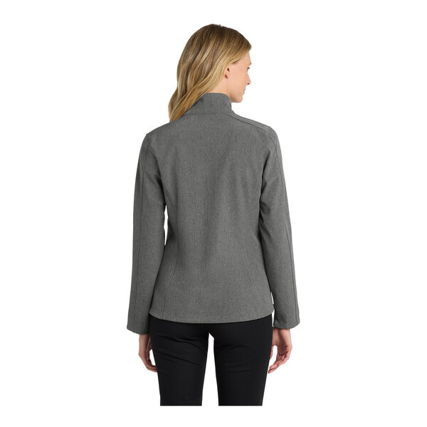 A woman wearing a Port Authority Core Soft Shell Jacket in pearl gray.