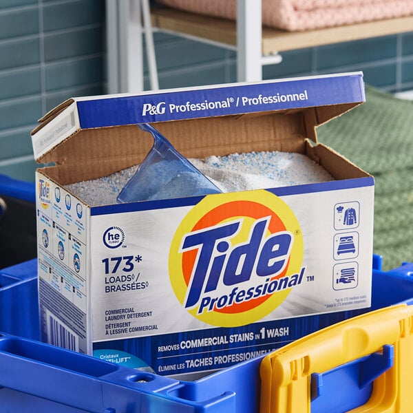 A box of Tide Professional powder laundry detergent with a scoop inside.