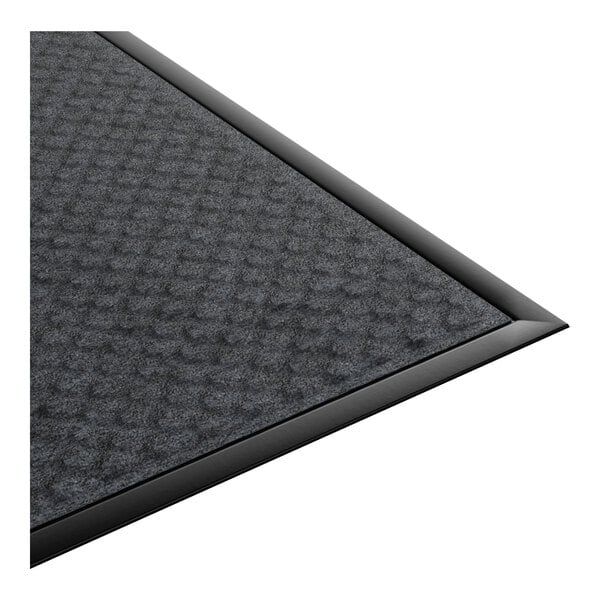 A rectangular, dark-colored anti-fatigue entrance mat with a textured surface and beveled edges.