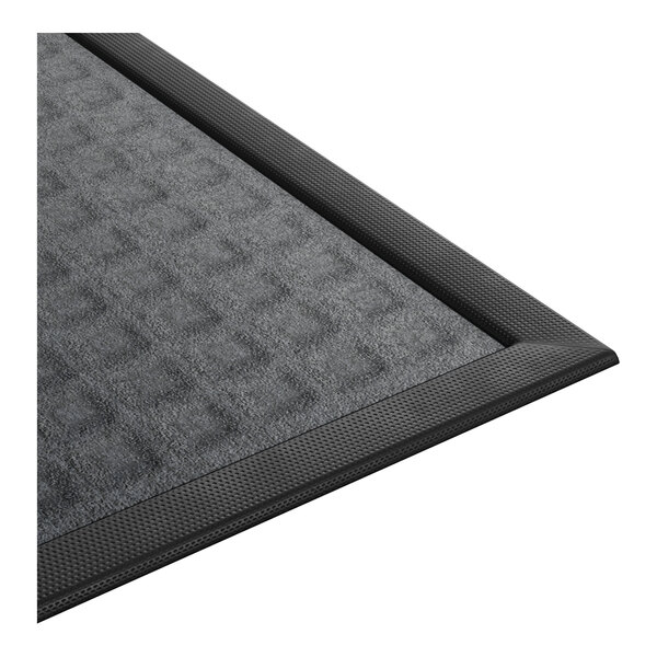 A rectangular gray entrance mat with a textured surface and a black rubber border.