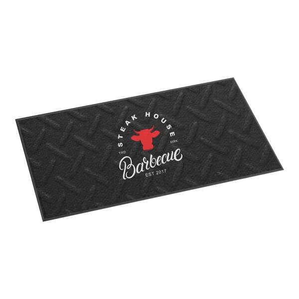 A rectangular black anti-fatigue entrance mat with a steak house barbecue design and customizable text.