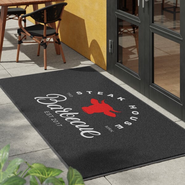 A large rectangular customizable entrance mat with a steakhouse and barbecue design, suitable for indoor or outdoor use.